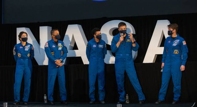 NASA astronaut Matthew Dominick, second from right, speaks to members of the news media following a National Space Council meeting inside the Apollo/Saturn V Center at the Kennedy Space Center.