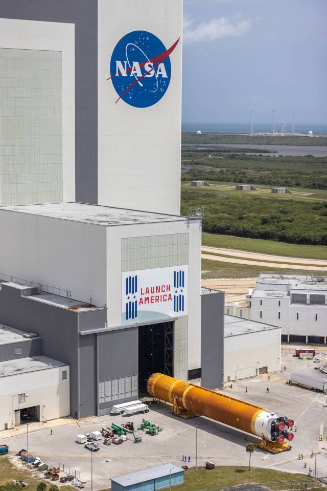 Teams with Exploration Ground Systems and lead contractor Jacobs transport the massive Space Launch System core stage to Kennedy's Vehicle Assembly Building following its arrival.