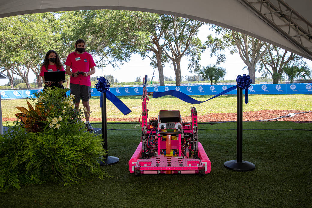 Rockledge High School’s 2021 competition robot cuts the ribbon during a ceremony commemorating the official start of operations for Florida Power and Light's new Discovery Solar Energy Center on June 11, 2021.