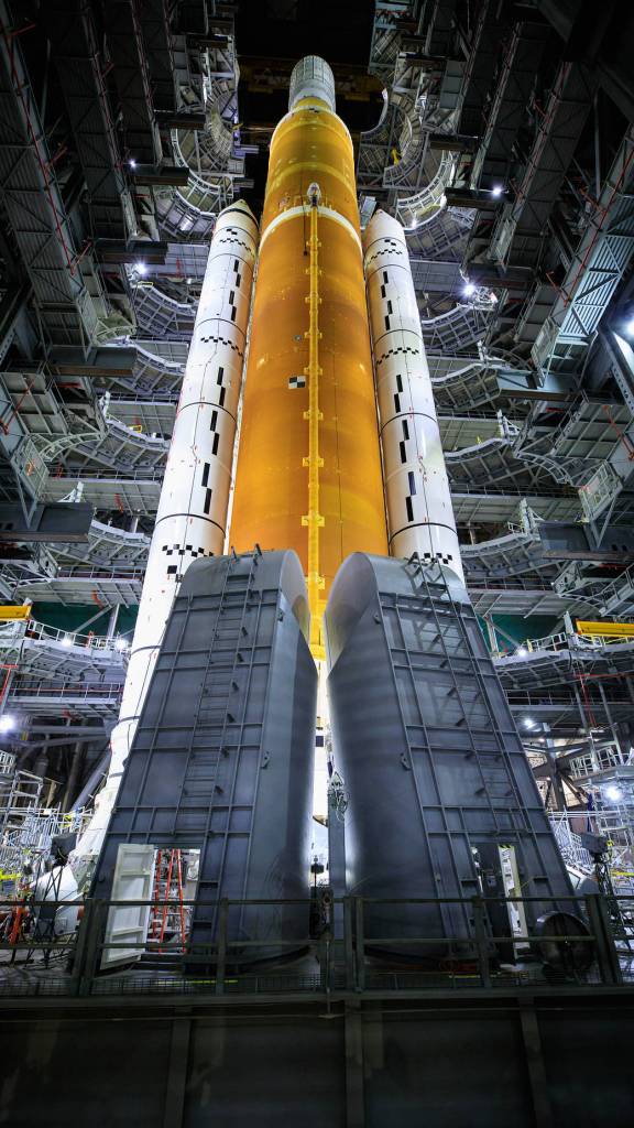 Inside High Bay 3 of the Vehicle Assembly Building, the work platforms have been retracted from around the Artemis I Space Launch System atop the mobile launcher as part of an umbilical test.