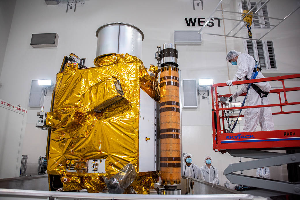 Technicians prepare to move NASA’s Double Asteroid Redirection Test (DART) spacecraft onto a work stand inside the Astrotech Space Operations Facility at Vandenberg Space Force Base in California following its arrival at the facility on Oct. 4, 2021.