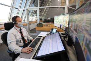 Wes Mosedale, Technical Assistant to the Launch Director, with Exploration Ground Systems, is seated at console inside Firing Room 1 of the Launch Control Center at Kennedy Space Center.
