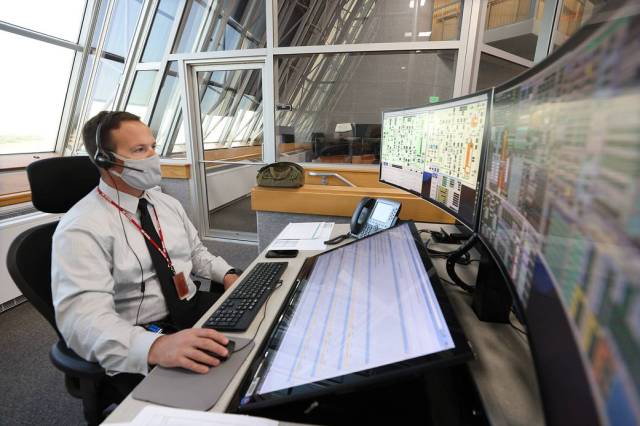 Wes Mosedale, Technical Assistant to the Launch Director, with Exploration Ground Systems, is seated at console inside Firing Room 1 of the Launch Control Center at Kennedy Space Center. 