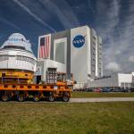 Boeing’s CST-100 Starliner spacecraft passes by the Vehicle Assembly Building at Kennedy, making its way to the Space Launch Complex-41 Vertical Integration Facility ahead of the OFT-2 launch.