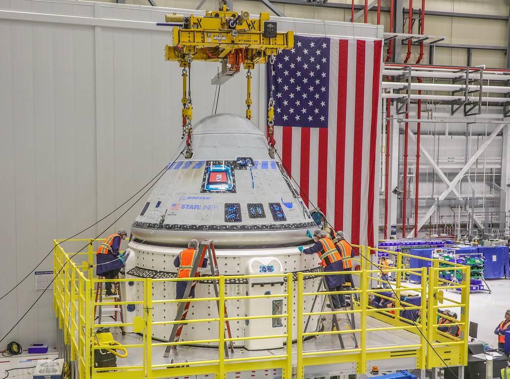 The Starliner team works to finalize the mate of the crew module and new service module for the Crew Flight Test that will take NASA astronauts Barry “Butch” Wilmore and Sunita “Suni” Williams to and from the International Space Station. 