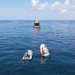 Support teams arrive at the SpaceX Crew Dragon spacecraft, with NASA astronauts Robert Behnken and Douglas Hurley onboard, shortly after it splashed down in the Gulf of Mexico.