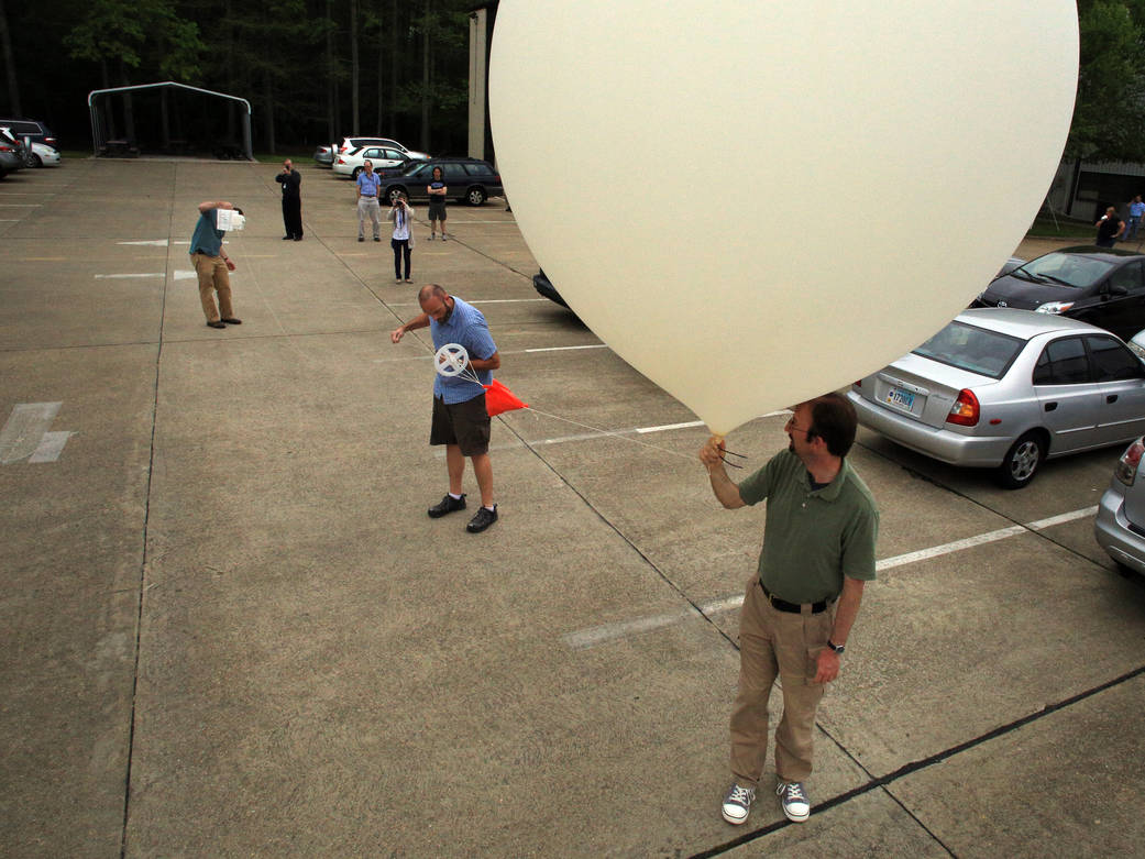 Launching a balloon for calibrating instruments measuring ozone.