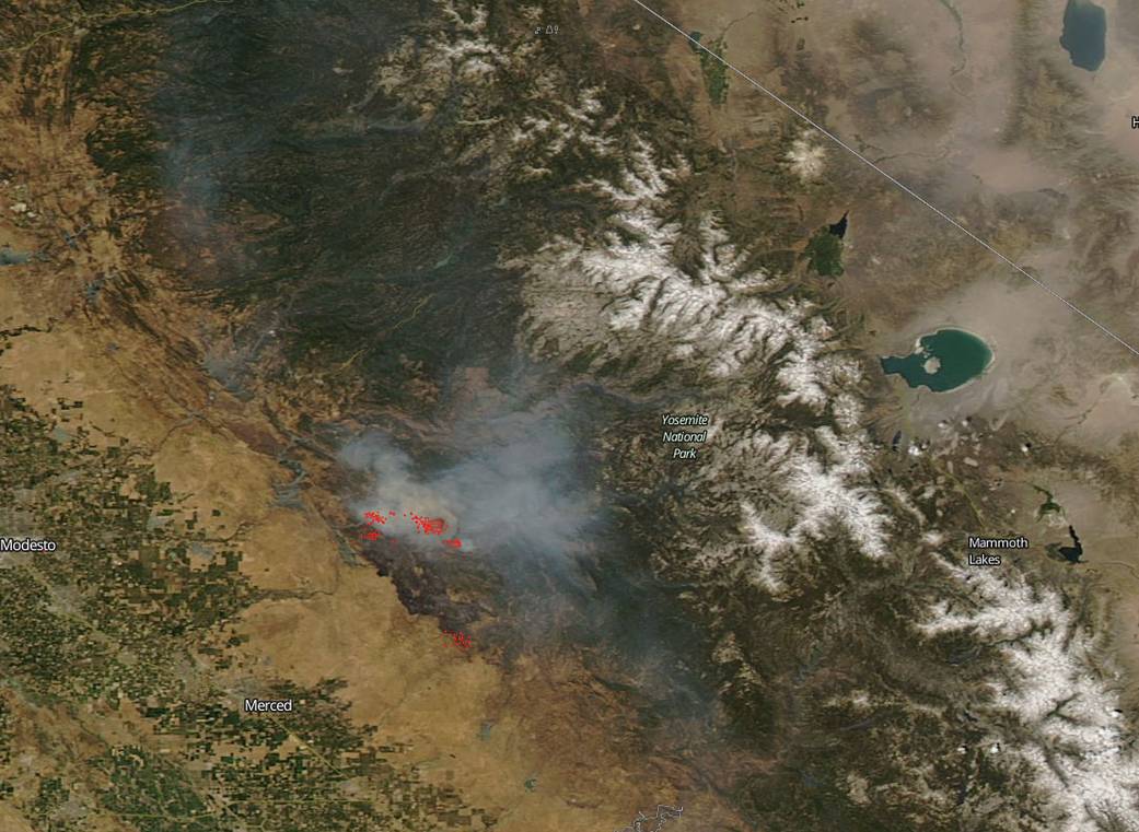satellite view of land with smoke 