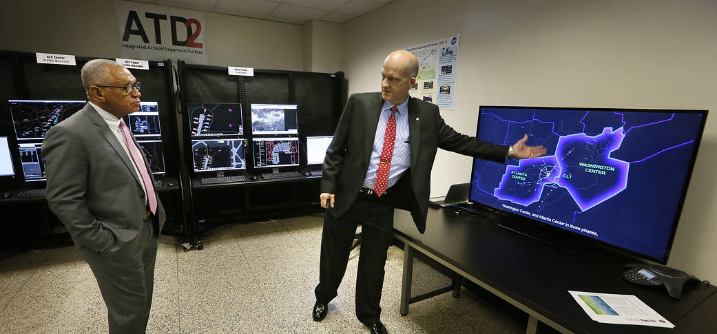 Shawn Engelland (right) briefs NASA Administrator Charlie Bolden on how multiple streams of data will be displayed.