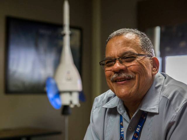 Gonzalez, pictured smiling, puts his passion for space into mentoring the next generation.