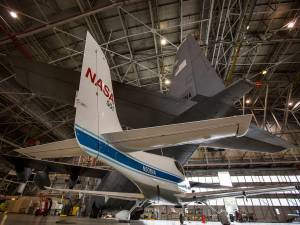 The NASA Wallops Flight Facility's C-130H Hercules dwarfs NASA Langley Research Center's Cirrus SR22 in the NASA Langley hangar.