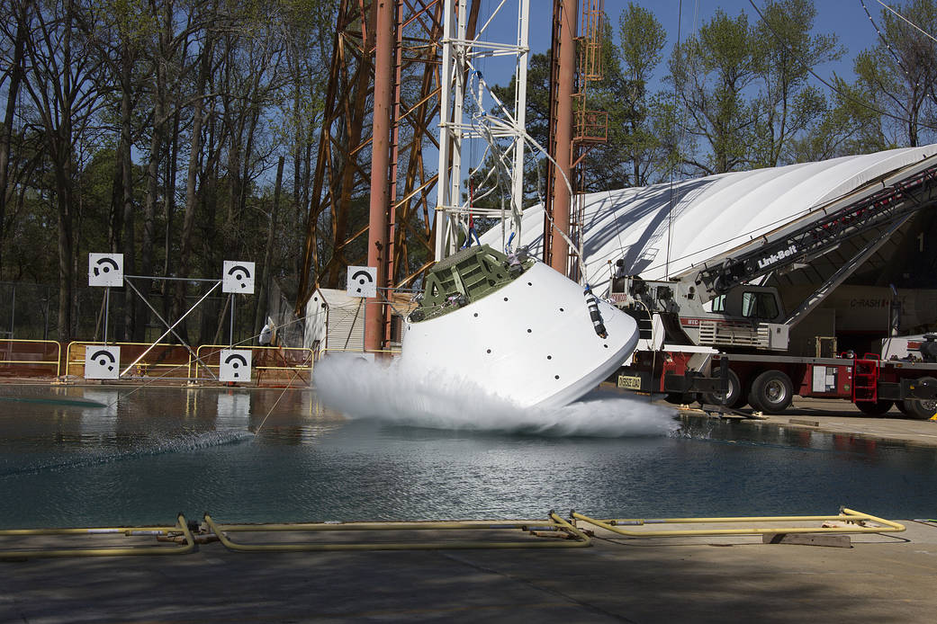 A high-fidelity Orion capsule — loaded with crash test dummies — is drop tested.