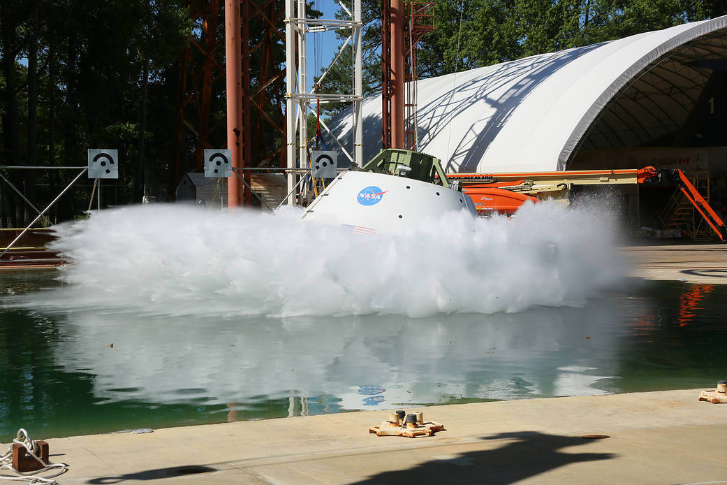 A test version of the Orion spacecraft is pulled back like a pendulum and released, falling 20 feet into the water.