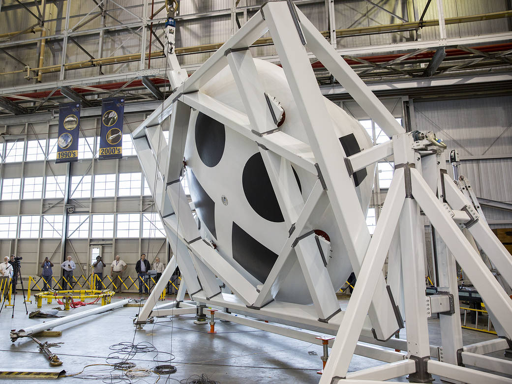 The Orion crew module test article for the Ascent Abort Test-2 is rotated in the hangar at Langley
