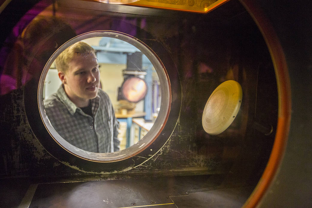 Engineer looks at Orion heat shield model in Mach 6 wind tunnel