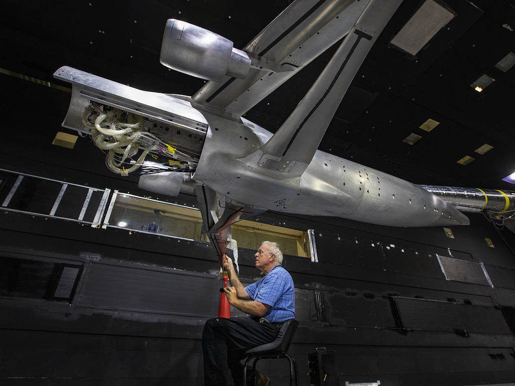 A man performs installation measures for the TTBW in 14x22 subsonic wind tunnel.