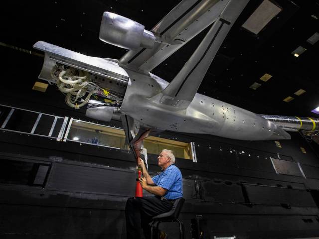 A man performs installation measures for the TTBW in 14x22 subsonic wind tunnel.