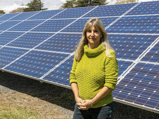 Ruth Amundsen, Aerospace Engineer at NASA Langley Research Center, in front of solar panels