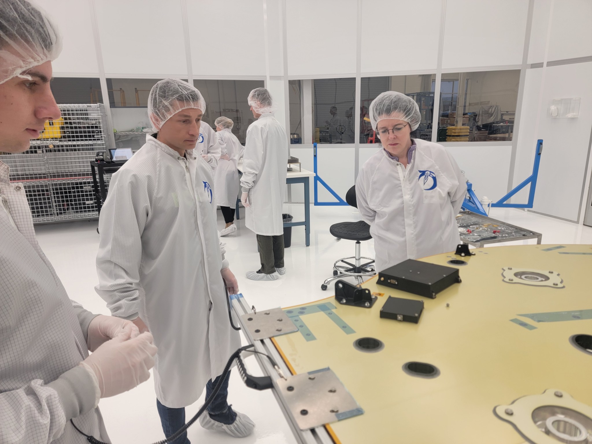 NASA, Firefly, Qascom, and ASI team members examining LuGRE hardware.