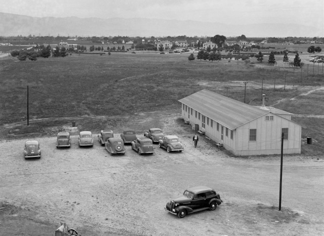 The original construction shack at Ames is featured in this view looking toward the southwest. Navy housing and buildings, still being utilized, can be observed in the center background.