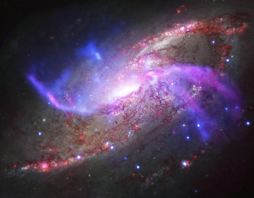 Spiral galaxy NGC 4258 puts on galactic light show with giant black hole, shock waves and vast reservoirs of gas.