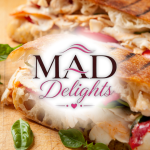 The Mad Delights food truck logo in front of a panini sandwich.
