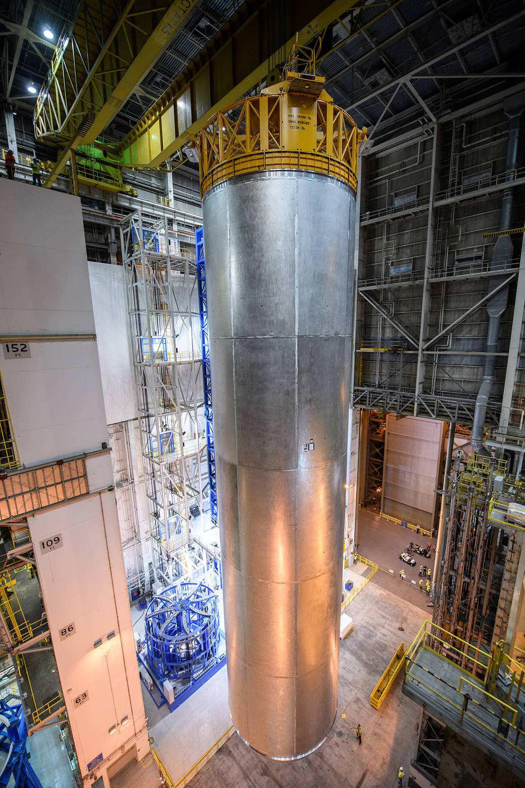 A qualification test article for the tank on the SLS is lifted off the Vertical Assembly Center after final welding.