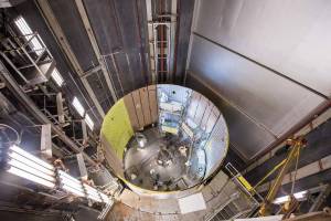 Technicians at Michoud perform priming operations on the SLS engine section qualification test article