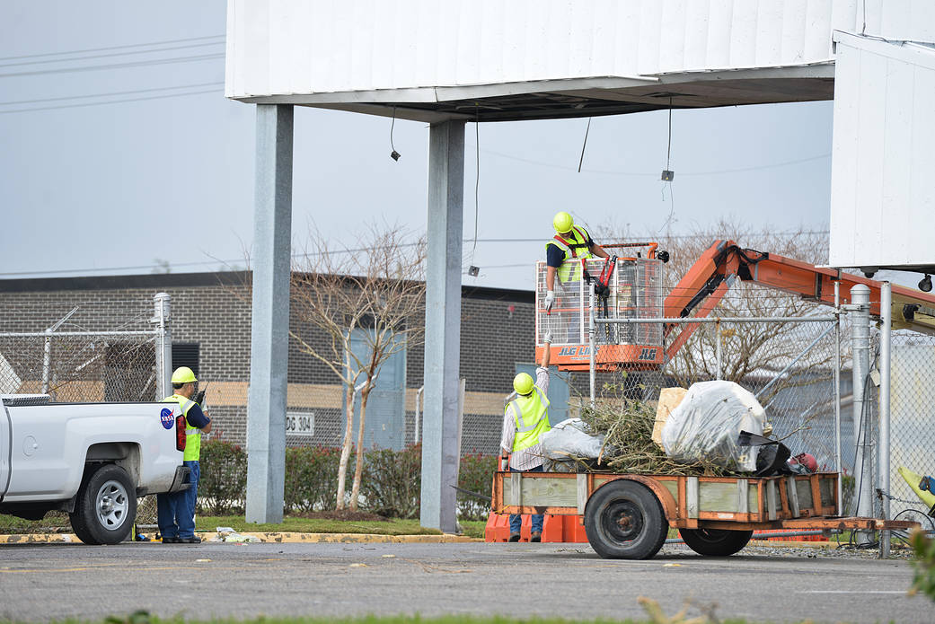 Workers with debris at NASA Michoud