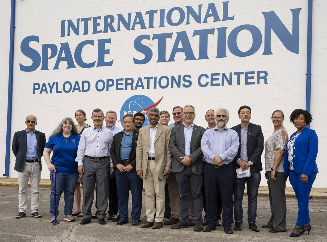 Senior officials from the Brazilian Space Agency, the Brazilian Ministry for Science, Technology, and Innovation, and a professor from Brazil’s Technological Institute of Aeronautics pose for a photograph with NASA team members in Huntsville, Alabama.