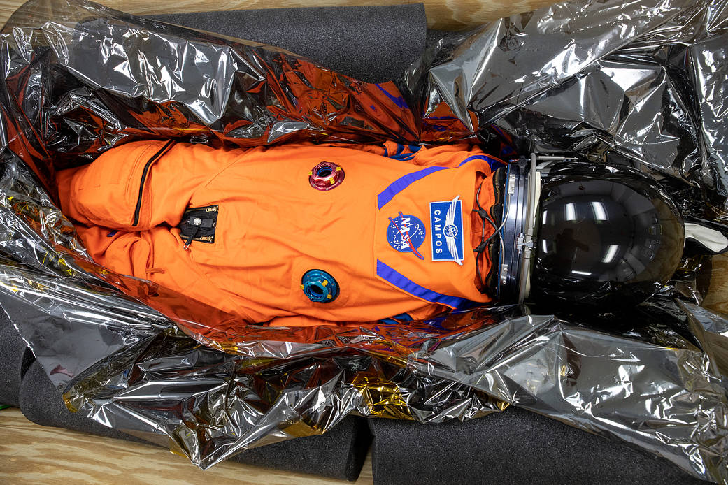 Commander Moonikin Campos, a sensored stand-in for humans from NASA’s Artemis I mission, is packed within its transport crate inside the Space Station Processing Facility at Kennedy Space Center in Florida on Jan. 10, 2023.