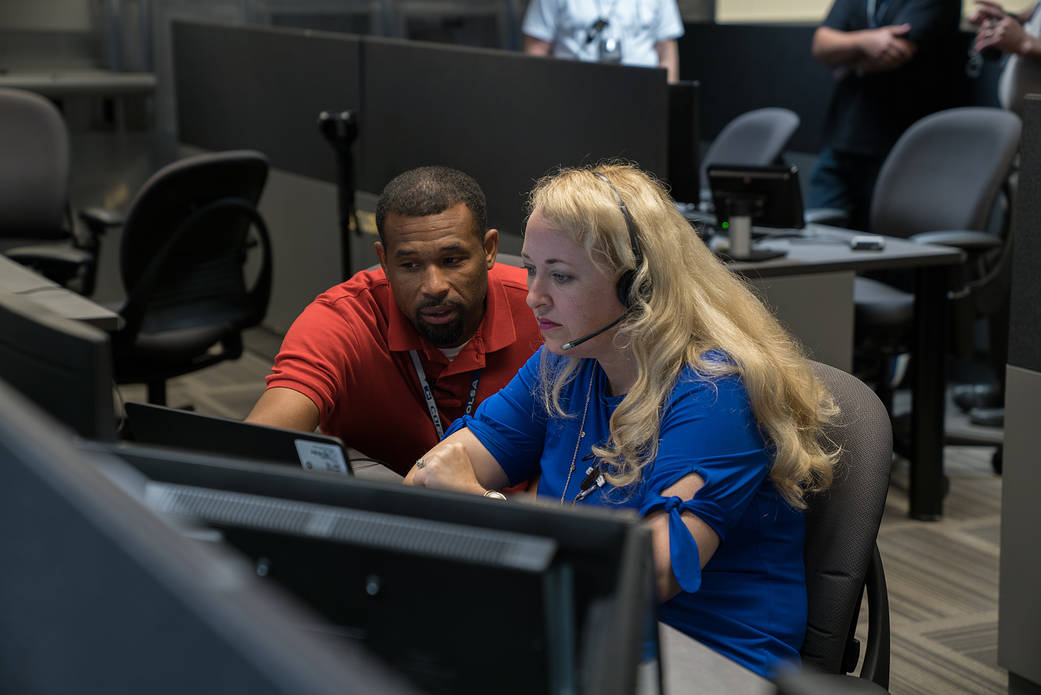 Engineers Fred Whisnant and Jennifer Vollmer check out communication systems during a big voice test Aug. 21, 2018.