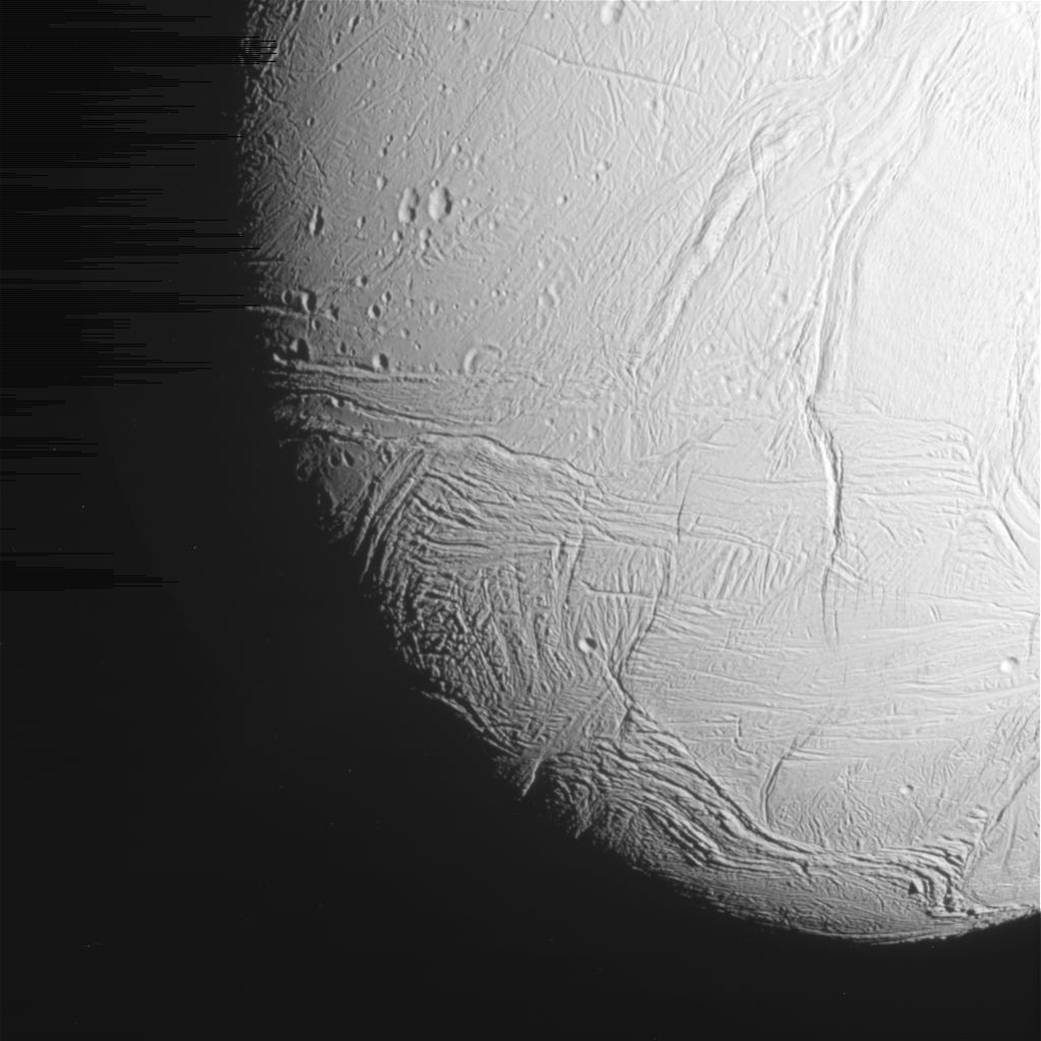 Closeup image of cratered surface of icy moon Enceladus