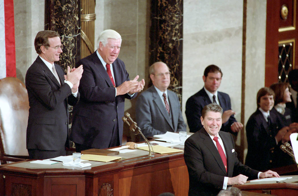 President Ronald Reagan with George Bush and Thomas "Tip" O'Neil applauding during the State of The Union Address to Congress and The Nation.