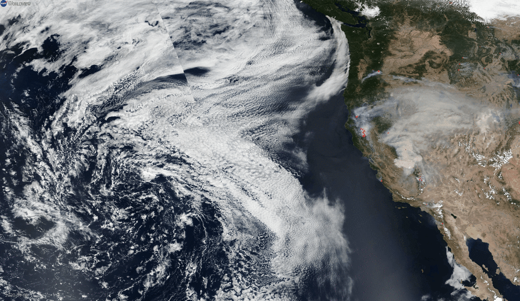Clouds of smoke cascade off the west coast of the United States