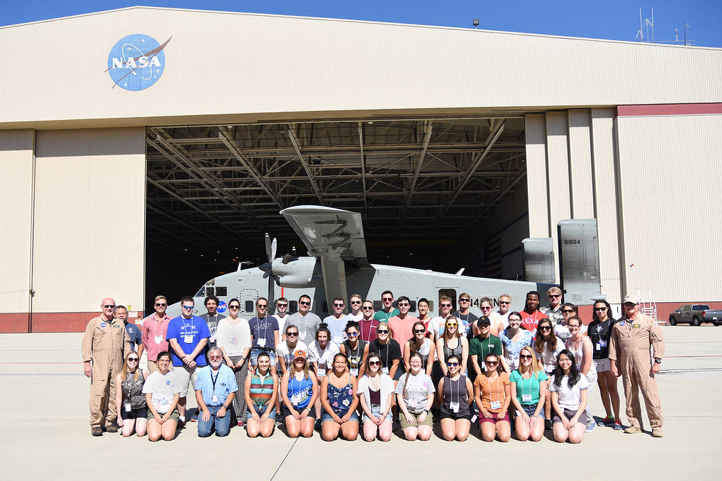 NASA Student Airborne Research Program interns pose for a group shot in front of the NASA C-23 Sherpa.
