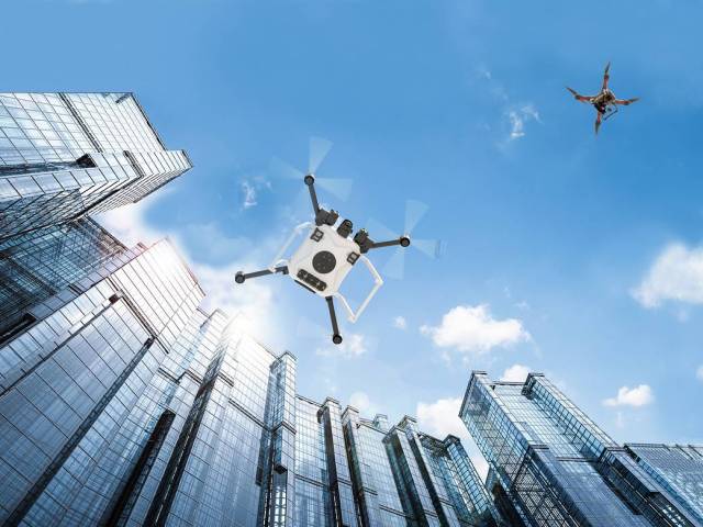 Artist illustration of drones in flight in a city.