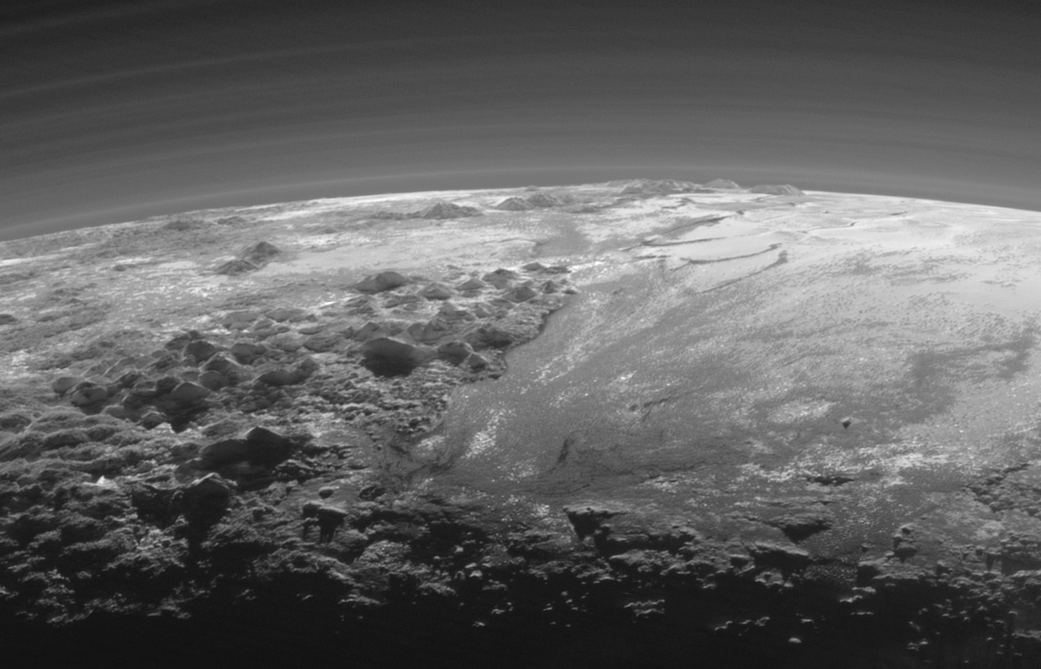 Pluto's mountains, frozen plains and foggy hazes