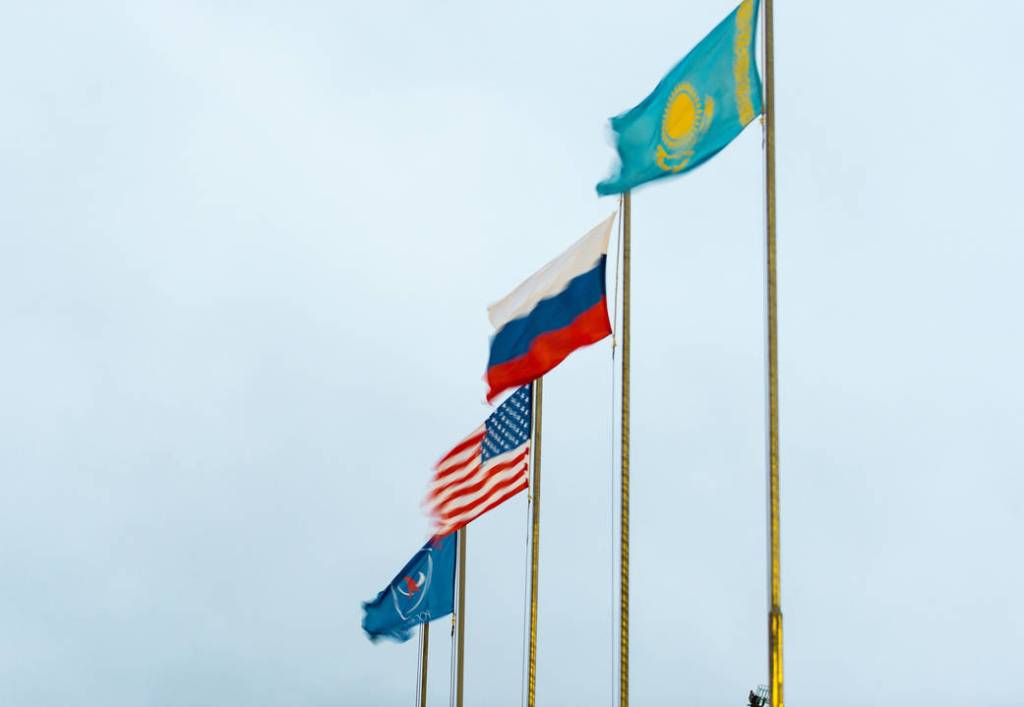 Flags of the U.S., Russia, Roscosmos, and Kazakhstan
