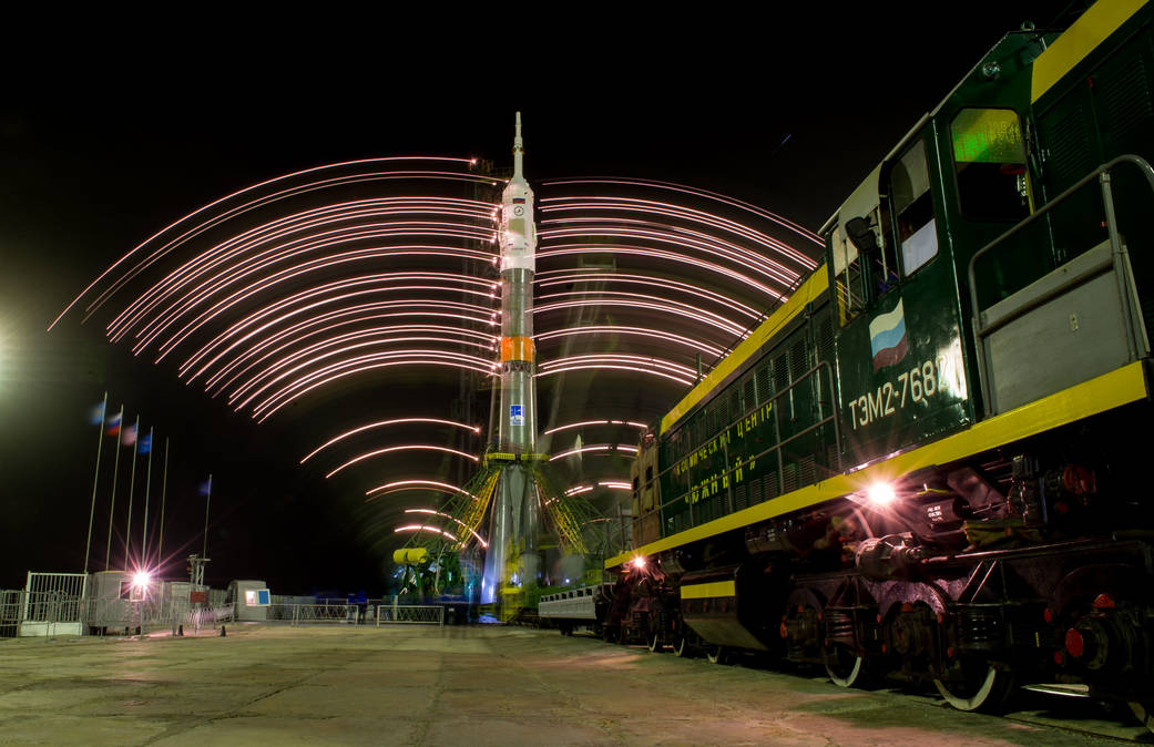 The gantry arms close around the Soyuz TMA-20M spacecraft