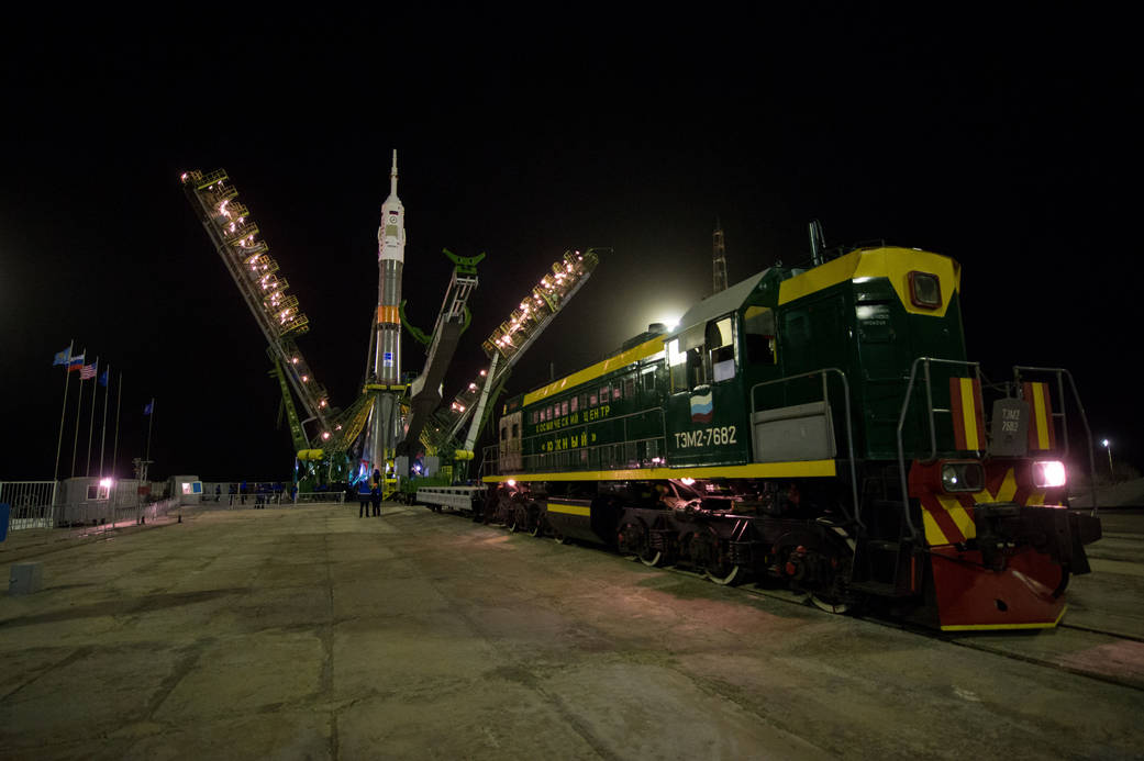 The gantry arms close around the Soyuz TMA-20M spacecraft