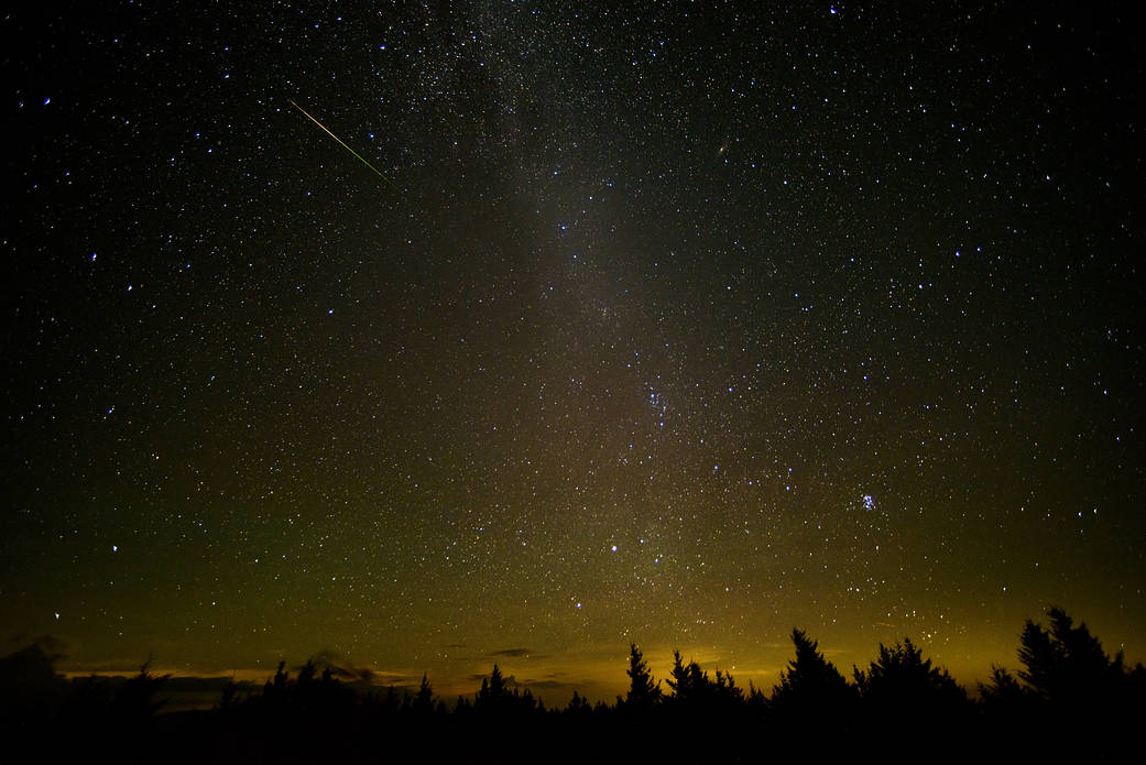 In this 30 second exposure, a meteor streaks across the sky during the annual Perseid meteor shower Friday, Aug. 12, 2016 in Spr