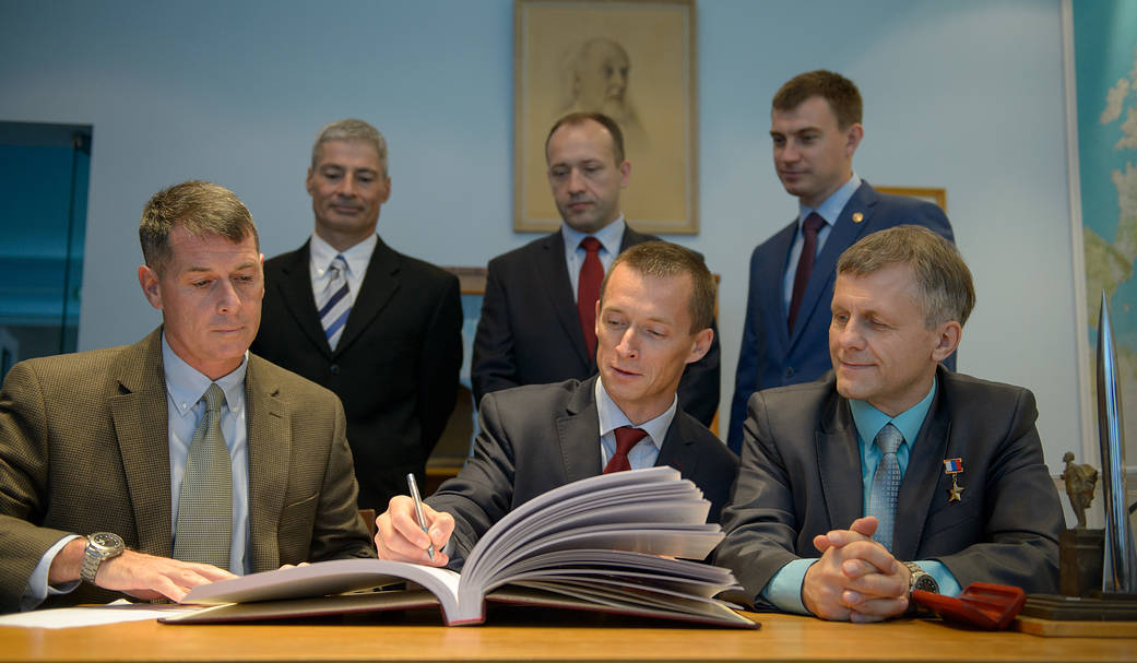 The Expedition 49-50 Crew Signs a Guest Book at the Gagarin Cosmonaut Training Center