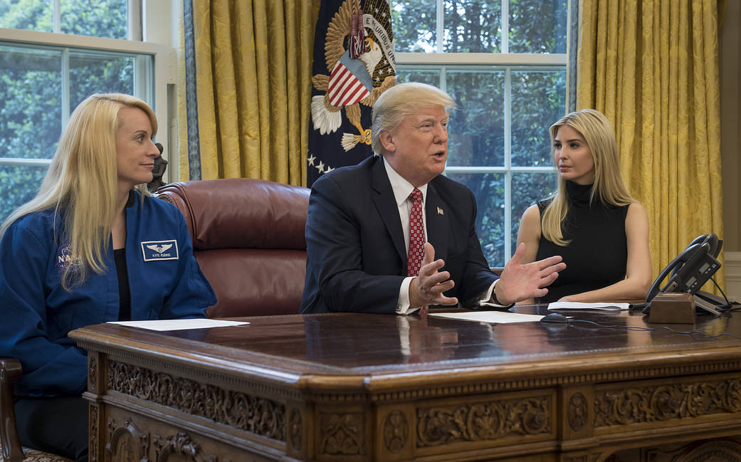 President Trump, Ivanka Trump and astronaut Kate Rubins at desk in Oval Office