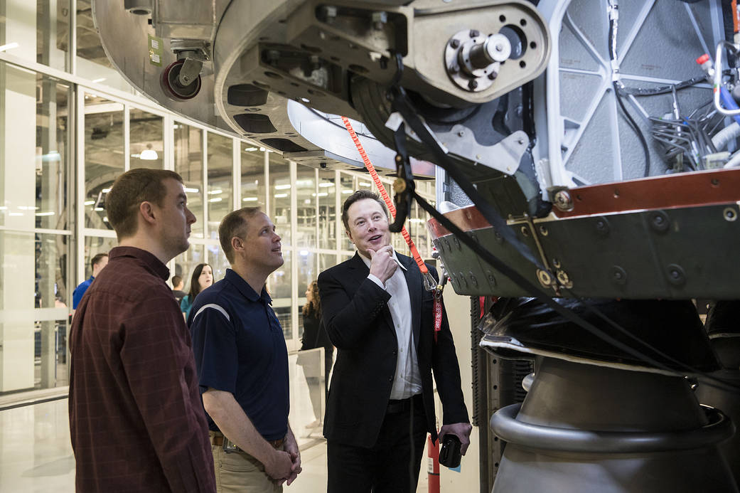 NASA Administrator Jim Bridenstine, center, speaks to SpaceX Chief Engineer Elon Musk while visiting SpaceX on Oct. 10, 2019.
