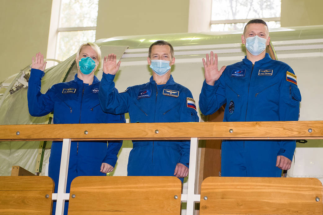 Expedition 64 crew members wave during Soyuz qualification exams
