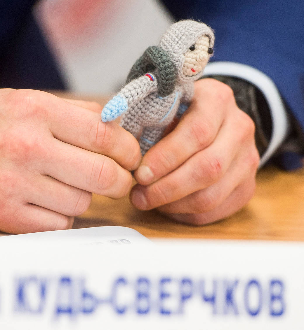 A knit cosmonaut named Yuri seen during a press conference