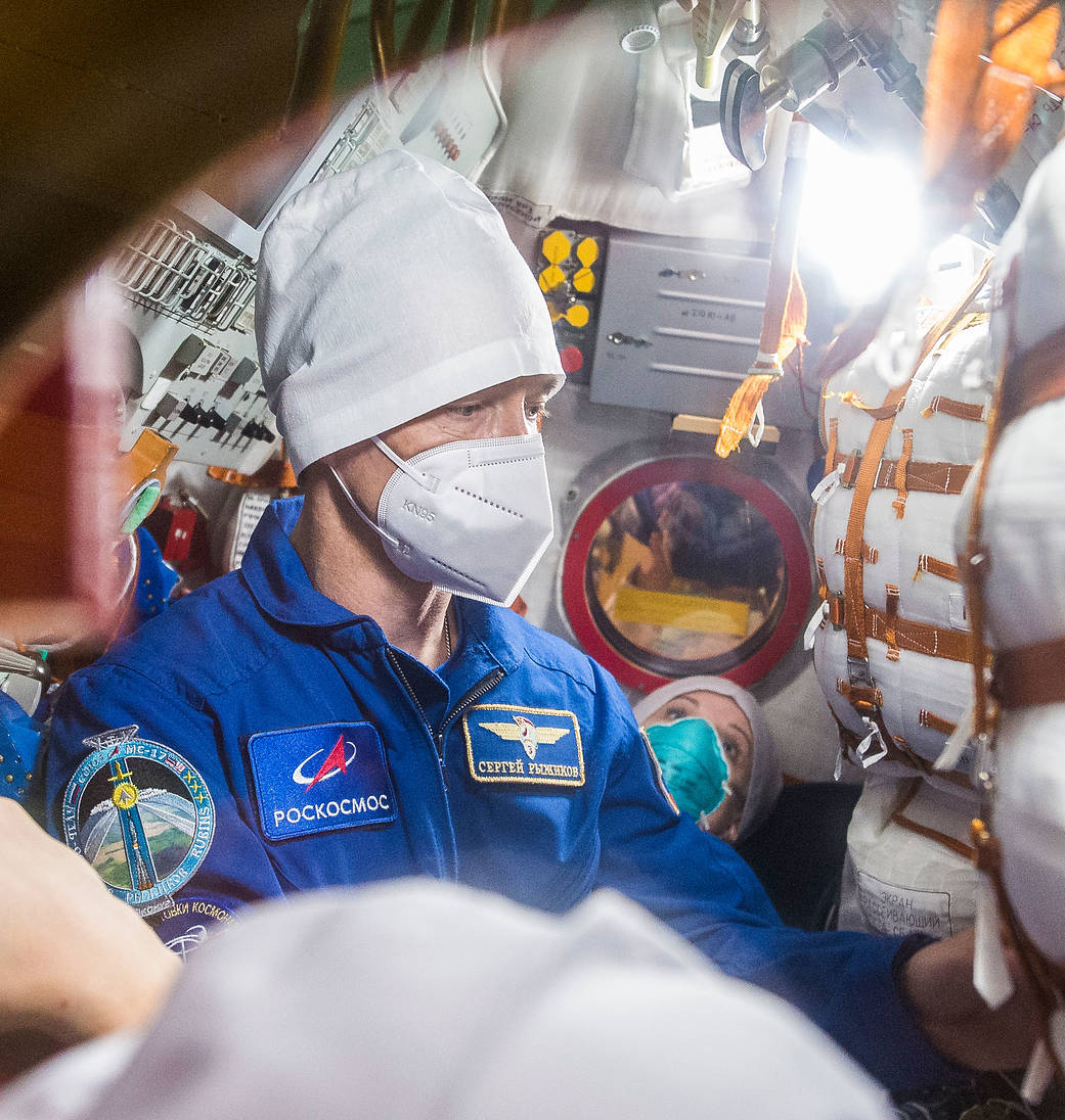 Expedition 64 crew members inside the Soyuz MS-17 spacecraft