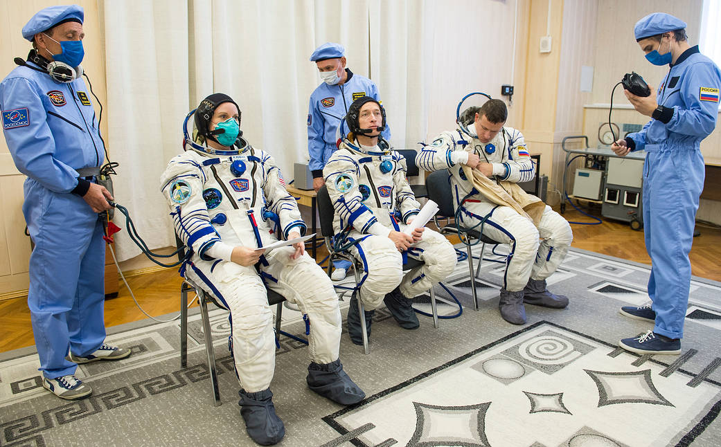 Expedition 64 crew members don their Sokol suits