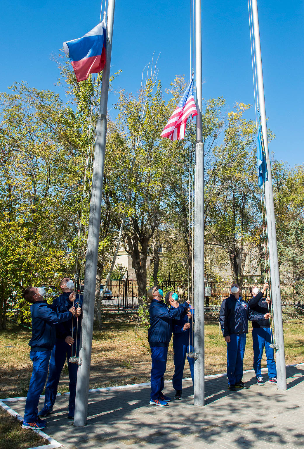 The Expedition 64 prime and backup crew members raise flags